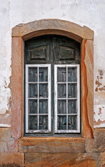 Ancient colonial window in historical city of Ouro Preto, Brazil 
