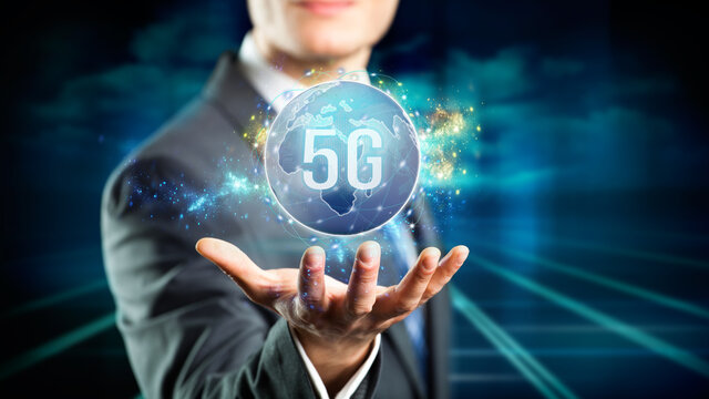 businessman presenting a virtual world map with message 5G in front of abstract background