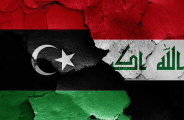 flags of Libya and Iraq painted on cracked wall