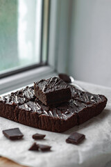 Homemade tasty chocolate brownie pieces. Side view. Vertical orientation