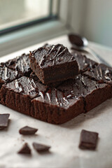 Homemade tasty chocolate brownie pieces. Side view. Vertical orientation