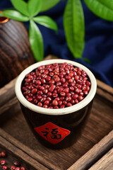 Red beans on the background of retro Chinese style.The Chinese meaning in the picture is happiness