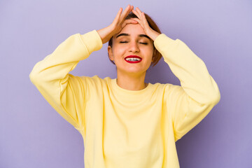 Young arab mixed race woman laughs joyfully keeping hands on head. Happiness concept.