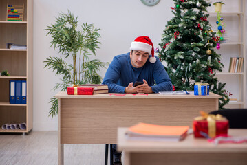 Young male student preparing for exams during new year celebrati