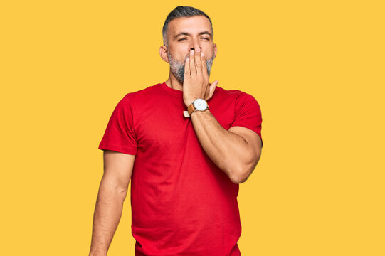 Middle age handsome man wearing casual clothes bored yawning tired covering mouth with hand. restless and sleepiness.