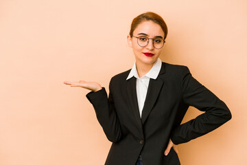 Young skinny caucasian business woman isolated showing a copy space on a palm and holding another...