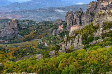 Fototapeta na wymiar Roussanou and Αgios Nikolaos monastery, an unesco world heritage site, located on a unique rock formation above the village of Kalambaka during fall season.