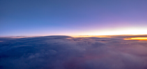 flying over rockies in airplane from salt lake city at sunset