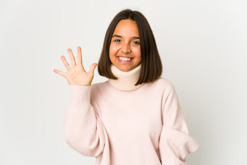 Young hispanic woman wearing a collar smiling cheerful showing number five with fingers.