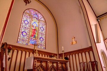inside church worship house with stained galss windows and pedestal