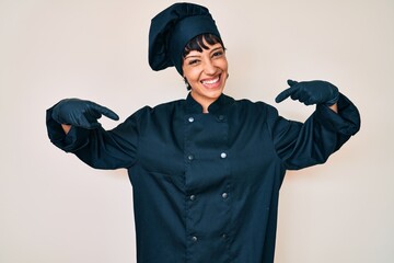 Beautiful brunettte woman wearing professional cook uniform looking confident with smile on face,...