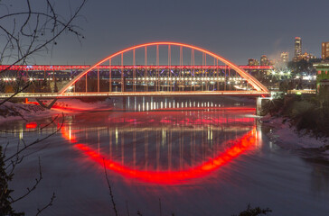 Remembrance Day Bridge Lit Up Red at Night Reflection on River