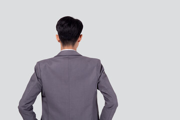 Rear view of young asian businessman in suit hand in pocket with confident isolated on white background, back of business man is manager or executive or employee thinking with success.