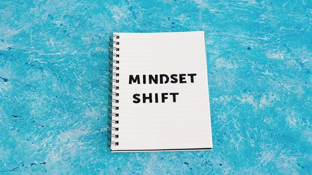 positivity and law of attraction, notepad with Mindset Shift text with different thought bubbles next to it