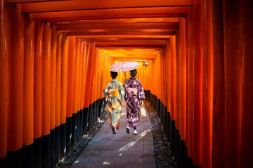 Rolgordijnen Women in traditional japanese kimonos walking at Fushimi Inari Shrine in Kyoto, Japan © Pawel Pajor