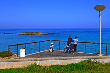 family admiring the beautiful sea