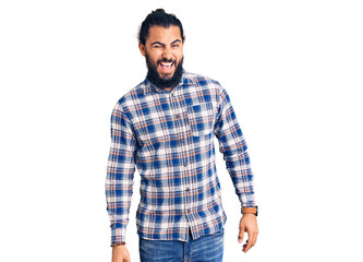 Fototapeta premium Young arab man wearing casual clothes winking looking at the camera with sexy expression, cheerful and happy face.