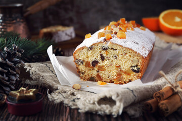 Christmas cake with candied orange and dried fruits, coffee and New Year decoration