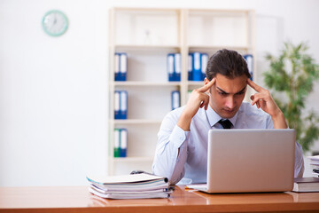 Young male employee working at workplace