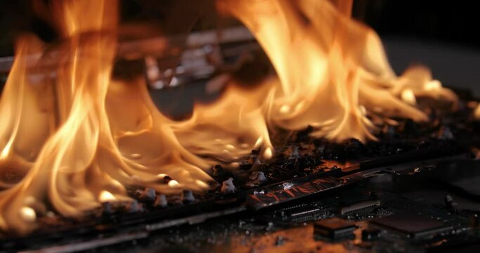 Laptop burning in flames on a desk, fire hazard. losing valuable data