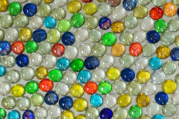 Fototapeta na wymiar Bright colorful shiny background made up of many small artificial round crystals. Abstract colorful background.
