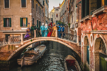 Fototapeta na wymiar Tourists dressed for carnival in Venice, Italy