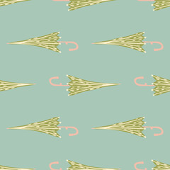 Decorative seamless simple pattern with hand drawn green umbrella elements. Blue background.