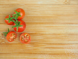 Ripe tomatoes on wooden board background, Fresh cherry tomatoes on wooden background, tomatoes on wooden background, Selective focus.