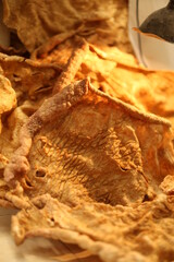 Chicharron de puerco prenzado , Mexican CHICHARRON. Fried pork chicharron on black plate.  view