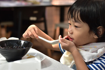 A cute little boy eating dessert