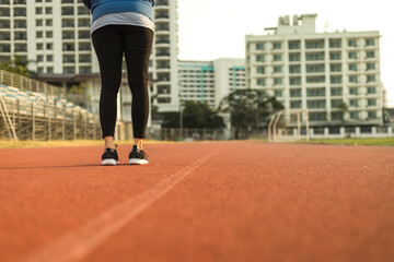 Fototapeta premium Healthy young woman stand on track race at sport stadium in the city.