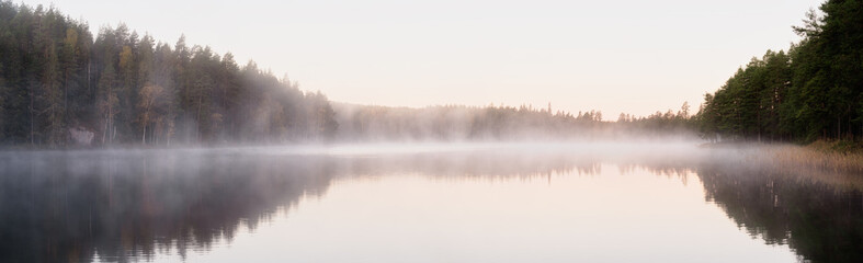 Foggy lake at sunrise in autumn season
