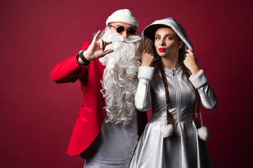 Dj Santa Claus with Sunglasses and Headphones Listening to Christmas Music and Snow Maiden Having Fun. Hip Hop Xmas Party Time.