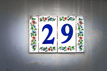 29, number twenty-nine, blue digits on floral tiles, vignetted.