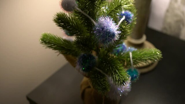 Mini homemade Christmas tree art at bed side table during evening