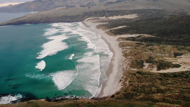 Sandfly Bay in Otago Peninsula aerial orbit. Cold morning on New Zealand coast.