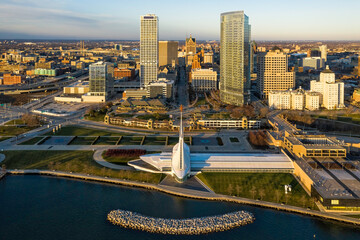 Aerial skyline panorama view of Downtown Milwaukee at sunset. Tall downtown buildings by the lake
