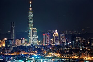 Fototapeta na wymiar Night scenery of Downtown Taipei, the vibrant capital city of Taiwan, with view of Taipei 101 Tower standing among high-rise buildings in Xinyi Financial District and city lights dazzling in the dark