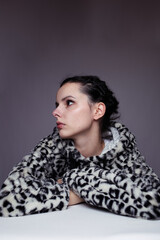 woman in hoodie, studio portrait on gray background