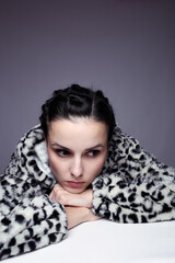 woman in hoodie, studio portrait on gray background