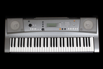 grey electronic synthesizer without labels , isolated on a black background.