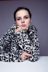 woman in hoodie, studio portrait on gray background