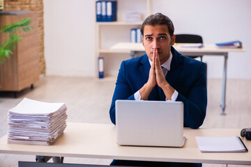 Fototapeta premium Young male employee working in the office