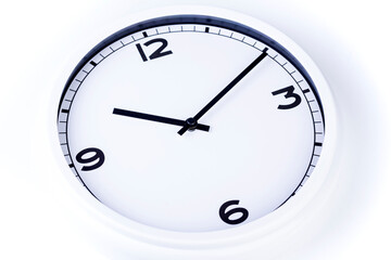 White analog clock with black hands set to time of 10:10