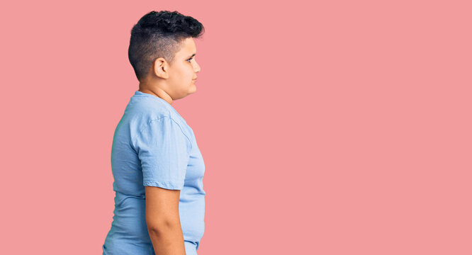 Little boy kid wearing sports workout clothes looking to side, relax profile pose with natural face with confident smile.