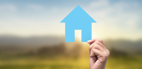 Naklejka premium Hands holding paper house, family home protecting insurance concept