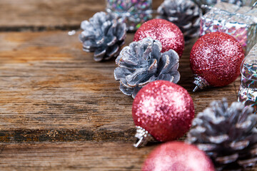 Christmas still life with balls and cones on a wooden background.
