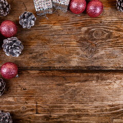 Christmas still life with balls and cones on a wooden background.