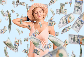 Young blonde woman wearing summer hat suffering of neck ache injury, touching neck with hand, muscular pain