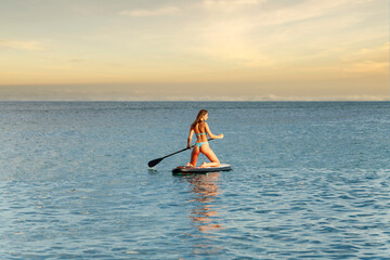 girl swims on a surfboard
